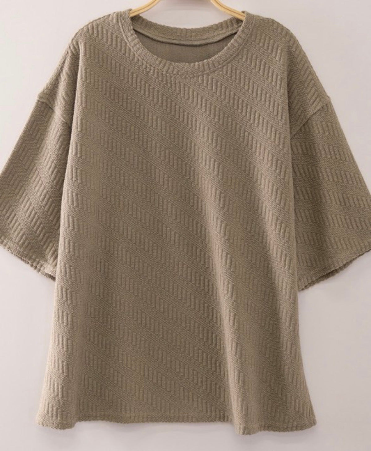 Muted taupe textured short sleeve top styled with jeans